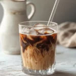 tahini iced coffee in glass with creamy swirl