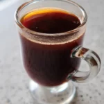prune juice apple juice and butter remedy in a cup
